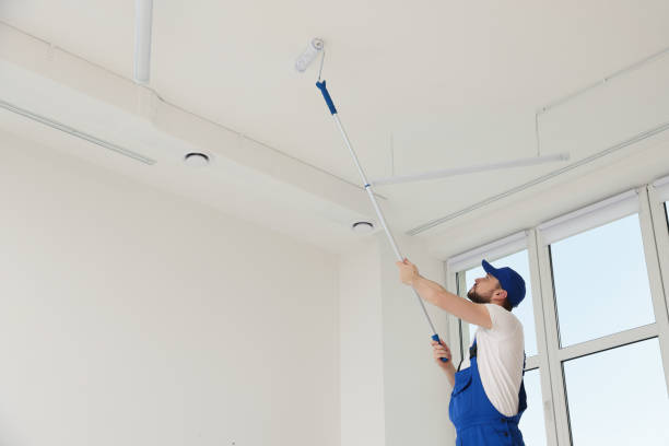 istock Worker in uniform painting ceiling with roller indoors. Space for text 1775146327