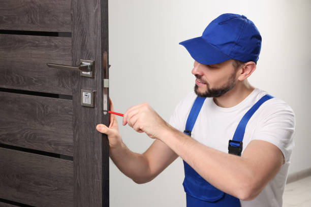 istock Worker in uniform with screwdriver repairing door lock indoors 1775146337