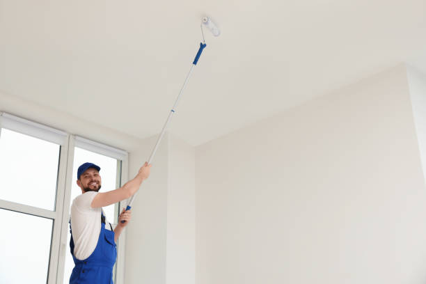 istock Worker in uniform painting ceiling with roller indoors. Space for text 1775146850