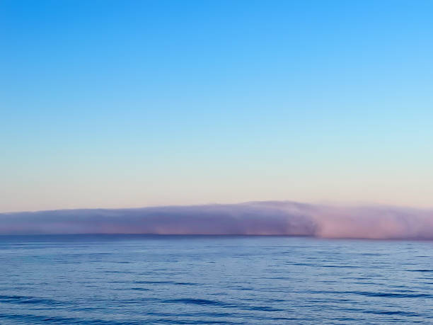 Clouds over Ocean in Shape of Wave at Sunrise