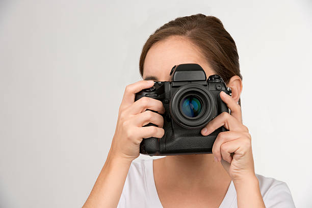 Young woman taking a picture stock photo