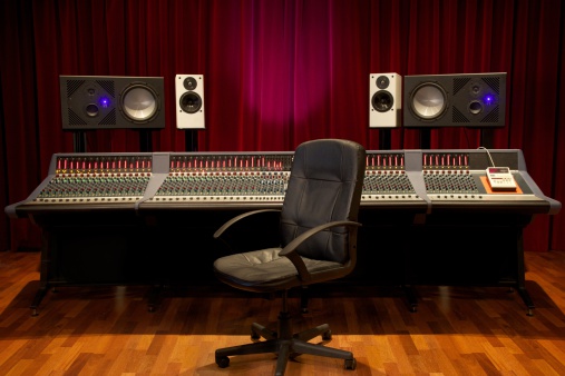 Chair standing in front of a large console mixing-desk
