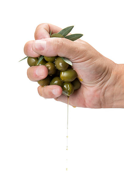 Handful of olives Handful of olives and olive oil dropping from it relish green food isolated stock pictures, royalty-free photos & images