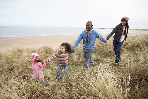 istock Family Walking Along Dunes On Winter Beach 177518099