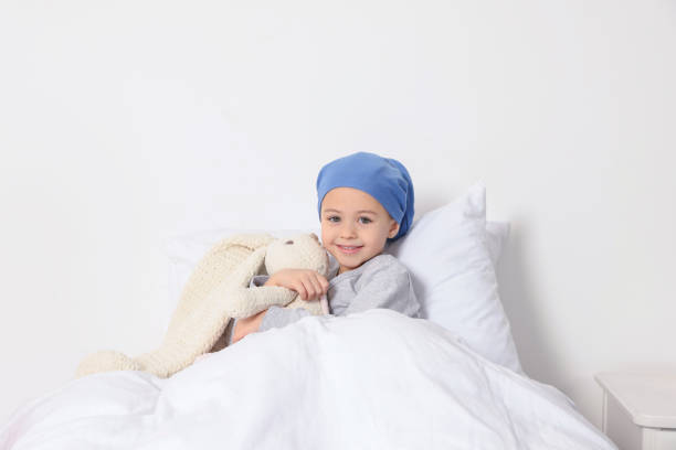 childhood cancer. girl with toy bunny in hospital - primary care imagens e fotografias de stock