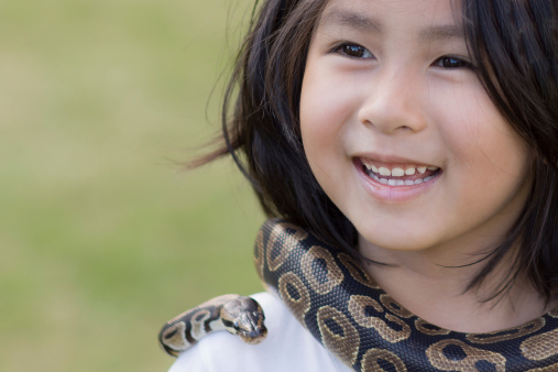 a cute little girl with pet snake