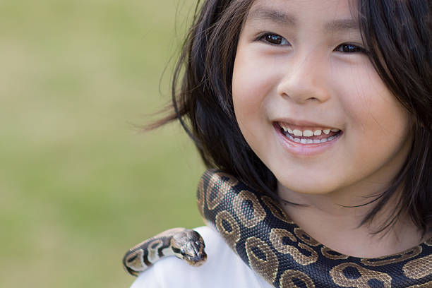 cute little girl a cute little girl with pet snake Boa stock pictures, royalty-free photos & images