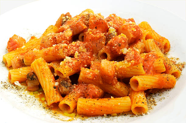 Rigatoni all'amatriciana Rigatoni all'amatriciana on a white background rigatoni stock pictures, royalty-free photos & images