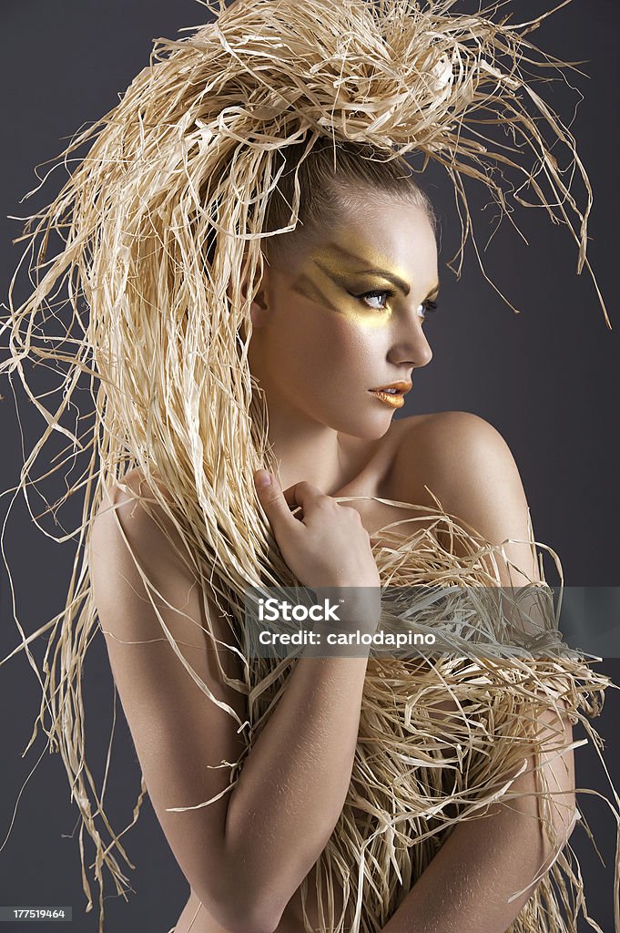 portrait of amazon girl beautiful and sexy girl with raffia hair and a ethnic costume in a shot over dark with creative make up Adult Stock Photo