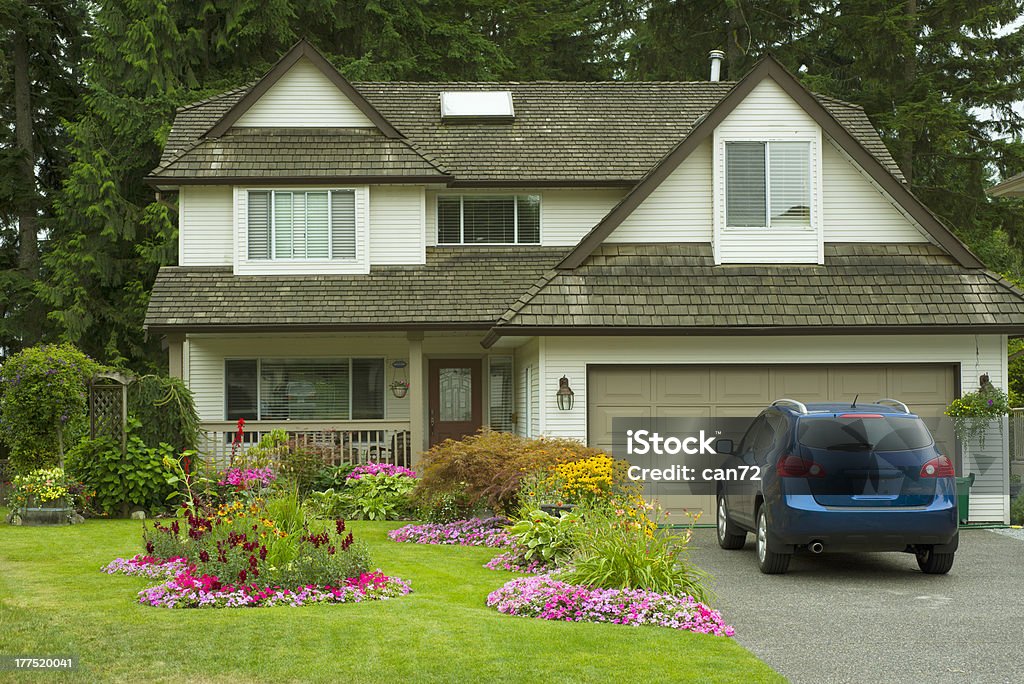 Manicured Home and Yard A beautiful Home and manicured yard with a garden full of perennials and annuals. Car Stock Photo