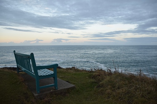 A solitary bench overlooking the sea.