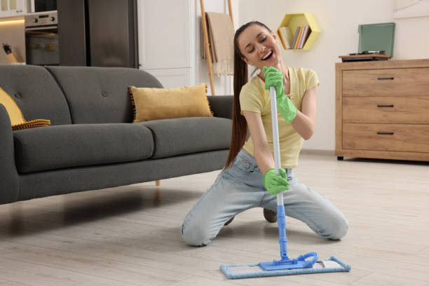 istock Spring cleaning. Young woman with mop singing while tidying up at home 1775202355