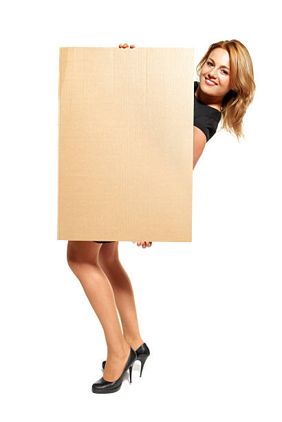 istock Attractive Woman Holding Up a Blank Sign - Isolated 177520335