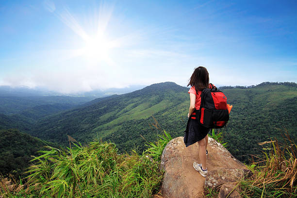 istock Young woman with backpack stand on a cliff 177520347
