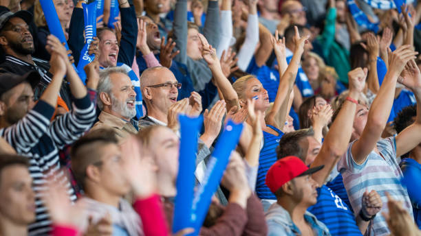 istock Spectators cheering in stadiumSpectators cheering in stadium 1775209537