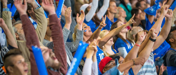 istock Spectators cheering in stadiumSpectators cheering in stadium 1775209559