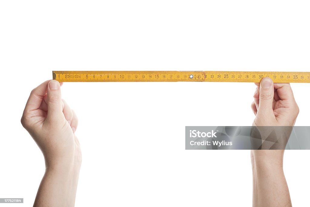 Hands holding wooden folding  ruler Hands holding wooden folding  ruler isolated on white Accuracy Stock Photo