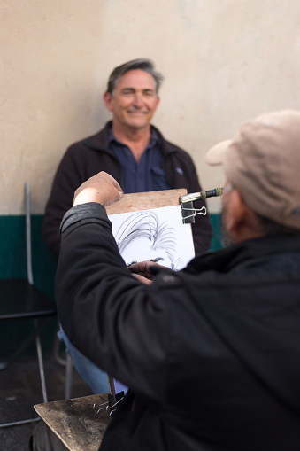 Paris, France: A Montmartre artist sketches a man’s portrait on the Place du Tertre in the 18th arrondissement.