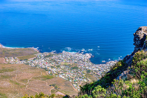 The town of Camps Bay as viewed from Table Mountain in Cape Town, South Africa. It is an affluent suburb of the City. Photo shot in the afternoon sunlight; horizontal format. Copy space.