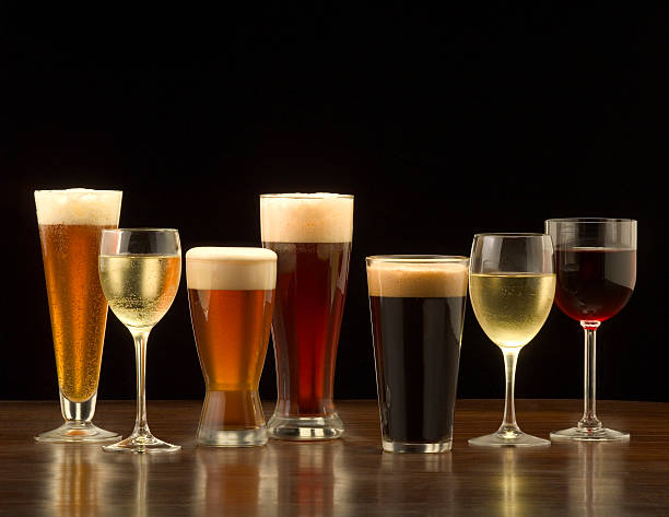 Beer and Wine "An assortment of glasses of wine and beer including a classic pilsner flute, a sparkling wine glass, an American half pint glass, a weizen or wheat beer glass, an American pint glass, a white wine glass, and a red wine glass." white wine photos stock pictures, royalty-free photos & images