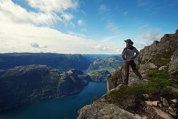 istock Man hiker looking over fjord panorama 177522091