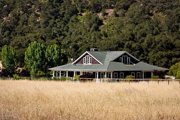 "A ranch house situated on rural property with a hayfield in the foreground, near Monterey, California.Other houses on acreage:"