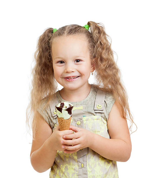 istock little curly girl eating ice cream in studio 177522511
