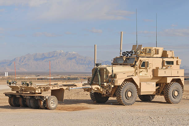 IED Patrol Afghanistan The MAXPRO version of the MRAP with the sparks mine roller attached in the desert of Afghanistan. armored vehicle stock pictures, royalty-free photos & images