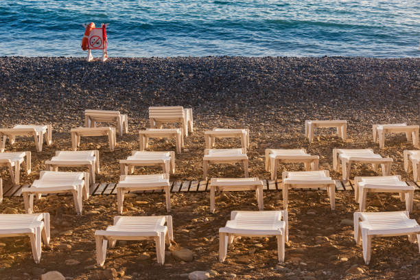 Beach loungers on the beach at sunset.