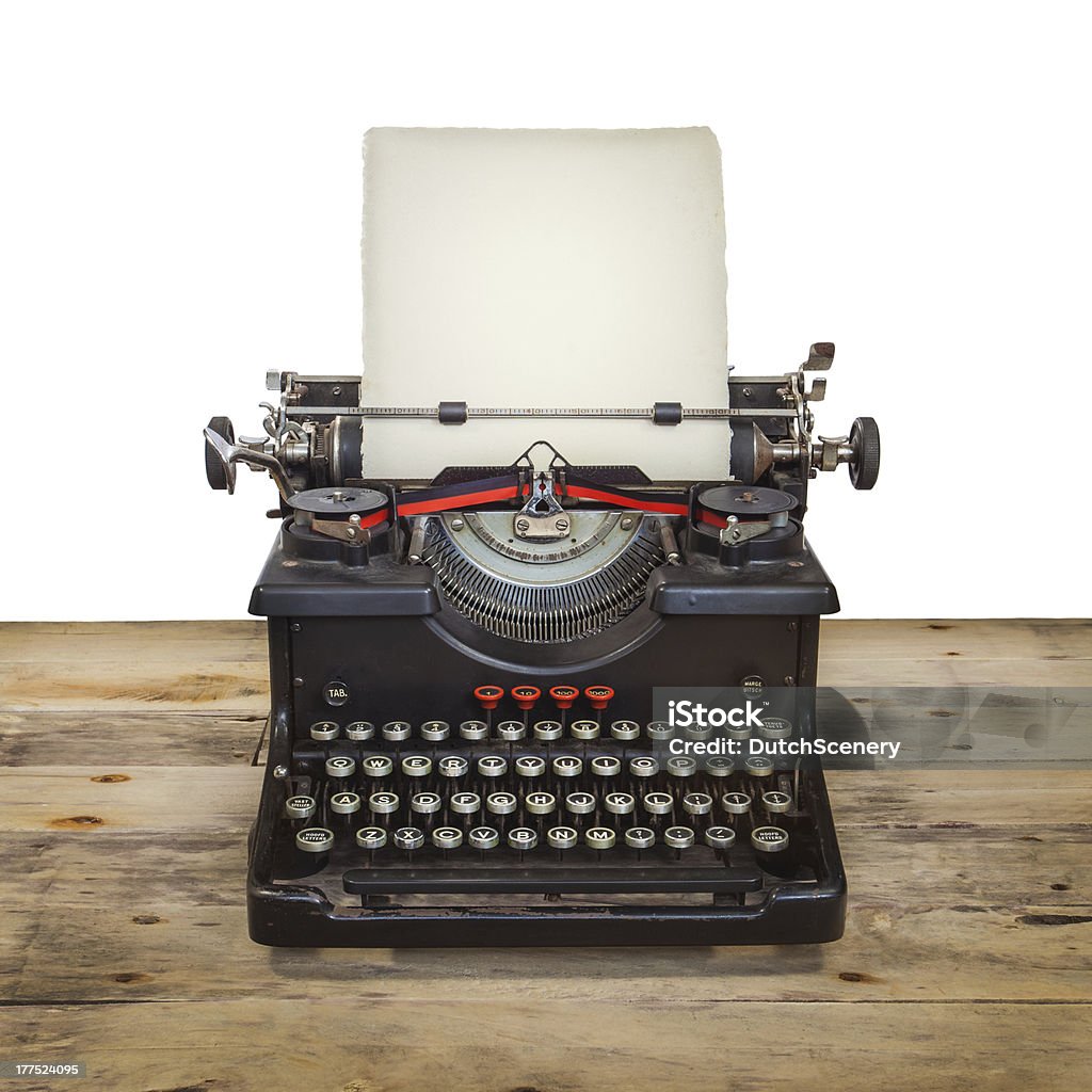 Old typewriter on a vintage wooden floor with white background Old Dutch typewriter on a vintage wooden floor isolated on white Antique Stock Photo