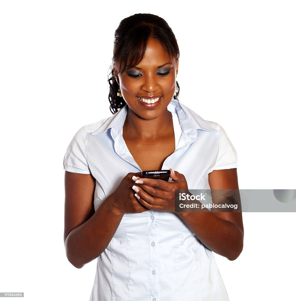 Charming young woman sending message by cellphone Charming young woman sending message by cellphone on isolated background Adult Stock Photo