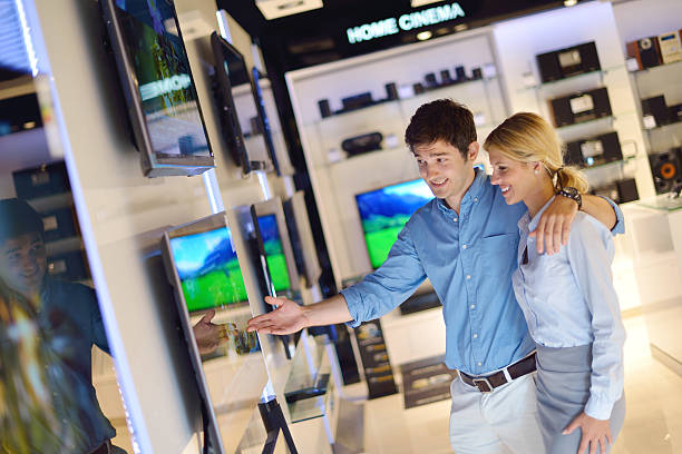 istock Couple looking at television sets in store 177524397