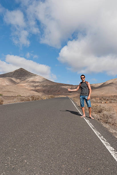 istock hitchhiking on desert road 177524440