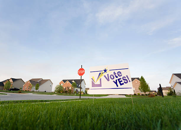 Lawn sign Image of a lawn sign in a neighborhood reading Vote Yes yard sign stock pictures, royalty-free photos & images