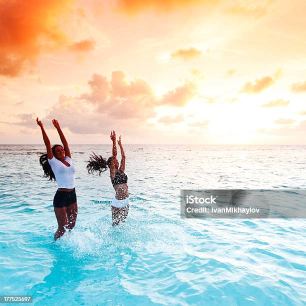Happy Women Playing In Water Stock Photo - Download Image Now - Activity, Adult, Adults Only