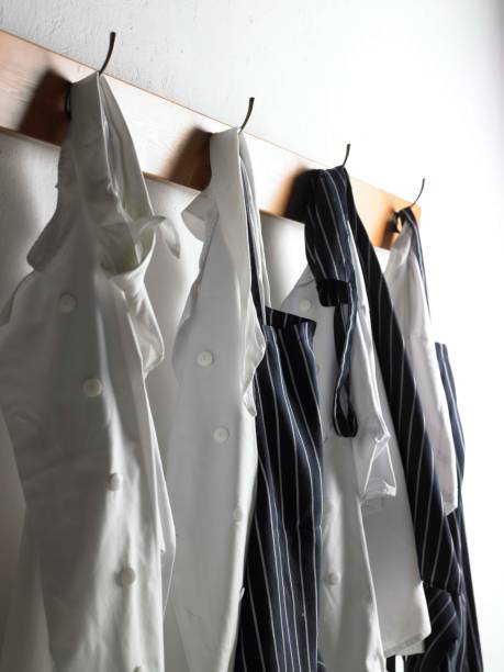 Chef's whites on hooks Chef's whites and aprons on coat hooks chefs whites stock pictures, royalty-free photos & images