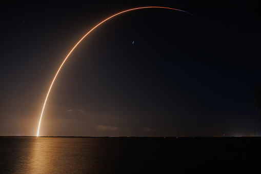 A United Launch Alliance Atlas V rocket heads to space from Cape Canaveral carrying a payload of an National Reconnaissance Office intelligence gathering satellite. The launch occurred just a few minutes after the sunset and the sun lit up the contrail as it rose.  Taken at Jetty Park in Cape Canaveral, a public viewing area.