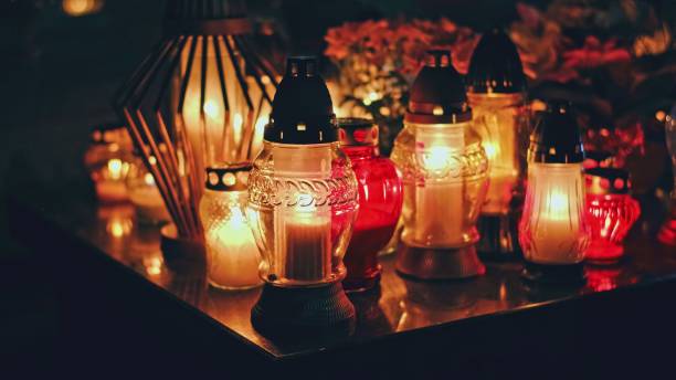 istock Cemetery Grave Tombstone Decorated with Candle Lanterns on All Saints Day Evening 1775269788