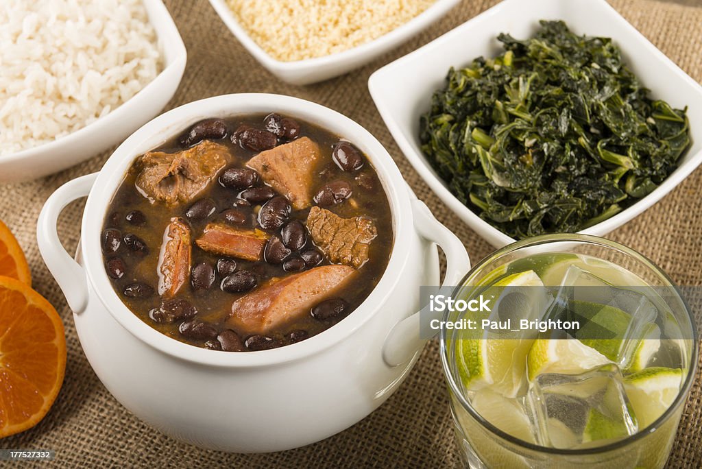 Feijoada "Brazilian beef, pork and sausage stew served with boiled rice, kale, oranges, manioc flour and caipirinha." Feijoada Stock Photo