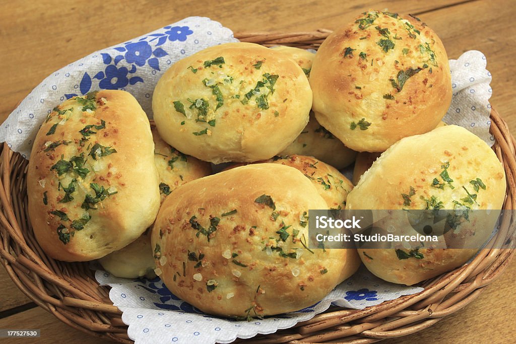 Garlic home made buns Home made buns with garlic and green parsley in wicker basket Baking Stock Photo