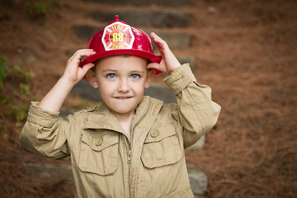 istock Adorable Child Boy with Fireman Hat Playing Outside 177527889