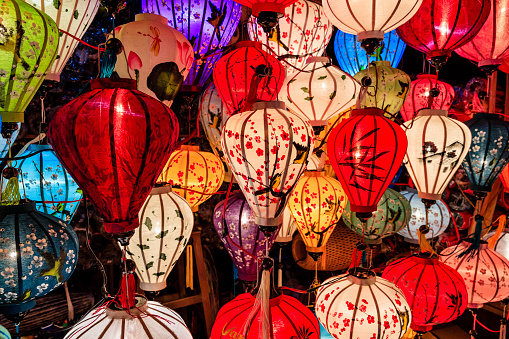 Asian ( Chinese / Vietnamese ) traditional silk hanging lanterns lanterns, night market in Hoi An. Hoi An is situated on the east coast of Vietnam. Its old town is a UNESCO World Heritage Site because of its historical buildings.