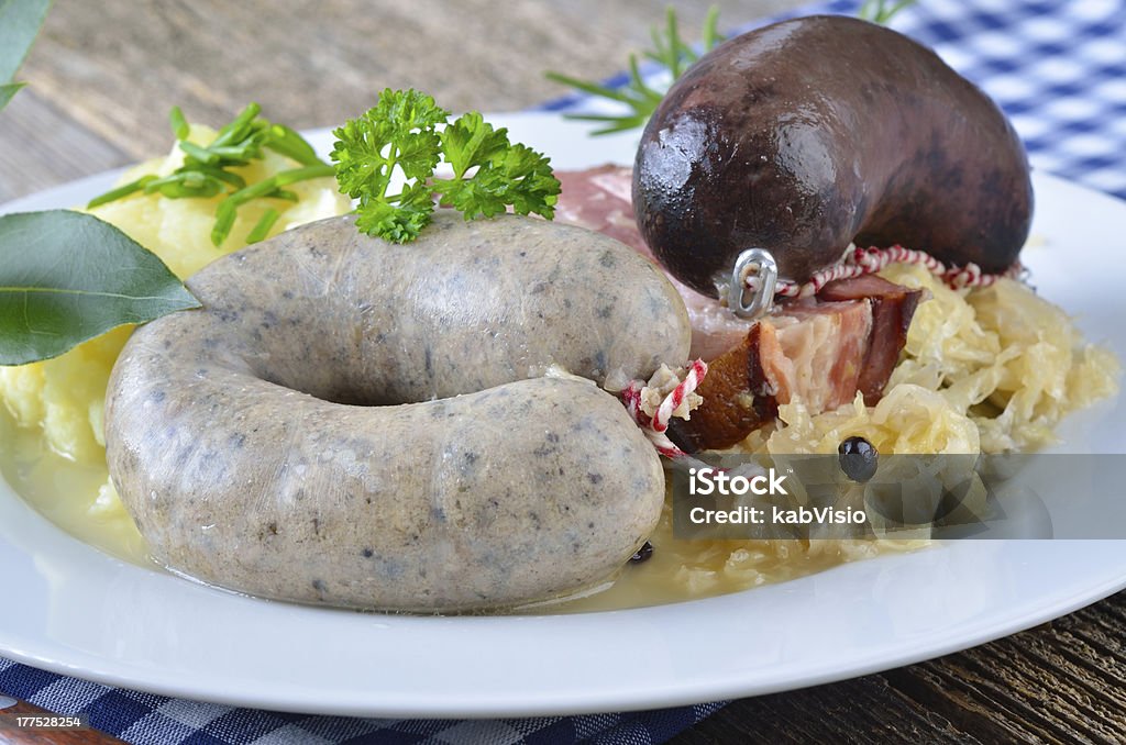Bavarian meat and sausage platter "Fresh black and white pudding, belly of pork, purree, sauerkraut" Black Pudding Stock Photo