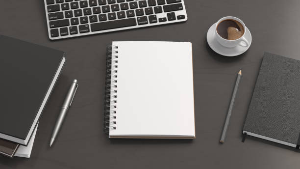 istock Notebook mockup. Blank workplace notebook. Spiral notepad on dark wooden desk 1775285474