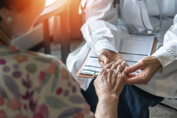 Parkinson disease patient, Alzheimer elderly senior, Arthritis person's hand in support of geriatric doctor or nursing caregiver for hospice palliative care, disability awareness day, ageing society care service stock photo