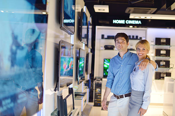 istock Young couple in consumer electronics store buy tv 177529386