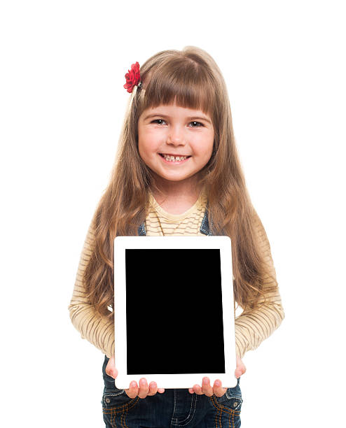 istock cute little girl posing in studio with white tablet gadget 177529596
