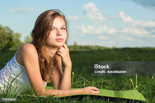 Young Female Relaxing In The Grass Stock Photo - Download Image Now - Grass, Horizontal, Innocence