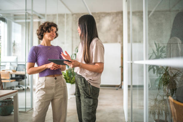 Female Digital Marketers Standing In the Modern Office