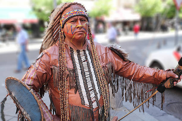 Man in the street dressed in traditional american indian costume.